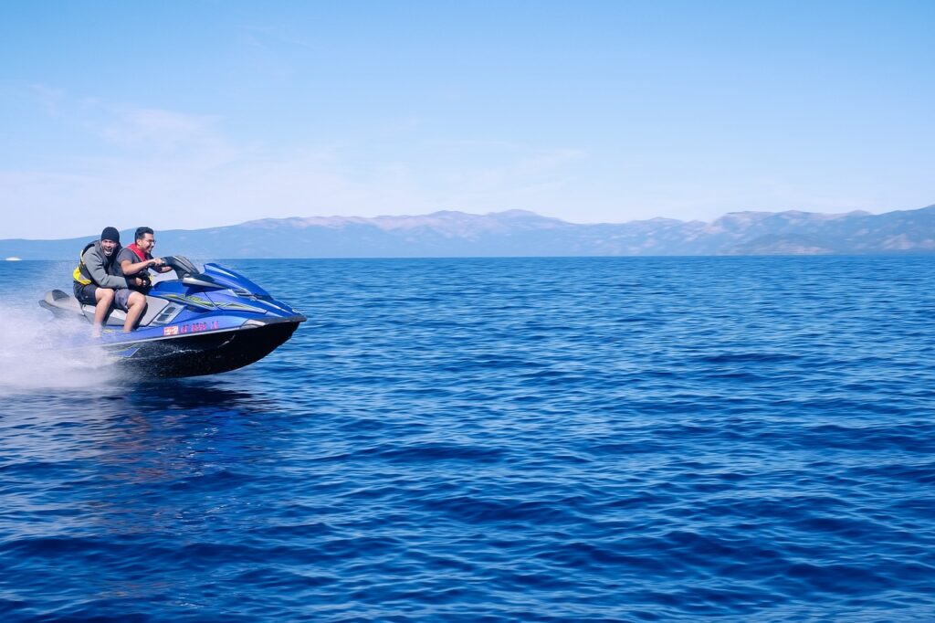 Jet ski rental business maintenance crew performing routine engine inspection and cleaning on a fleet of watercraft in Scarborough, ensuring optimal performance and safety for customers.