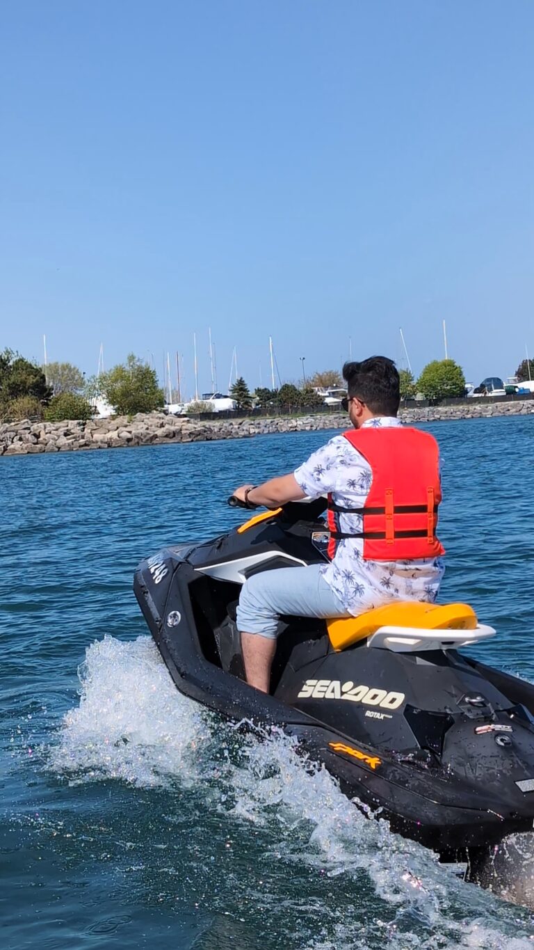 Person riding a Sea-Doo Spark jet ski on Lake Ontario near Bluffer’s Park Beach