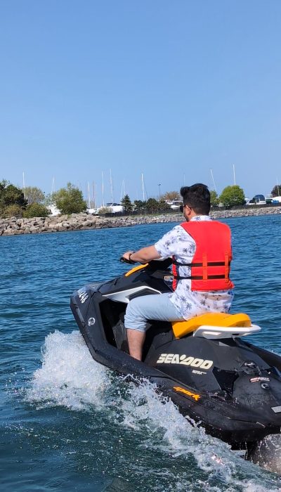 Person riding a Sea-Doo Spark jet ski on Lake Ontario near Bluffer’s Park Beach