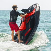 Two people riding Seadoo jet skis on Lake Ontario with the Toronto skyline in the distance, starting from Scarborough Bluffers Park and heading toward Woodbine Beach.